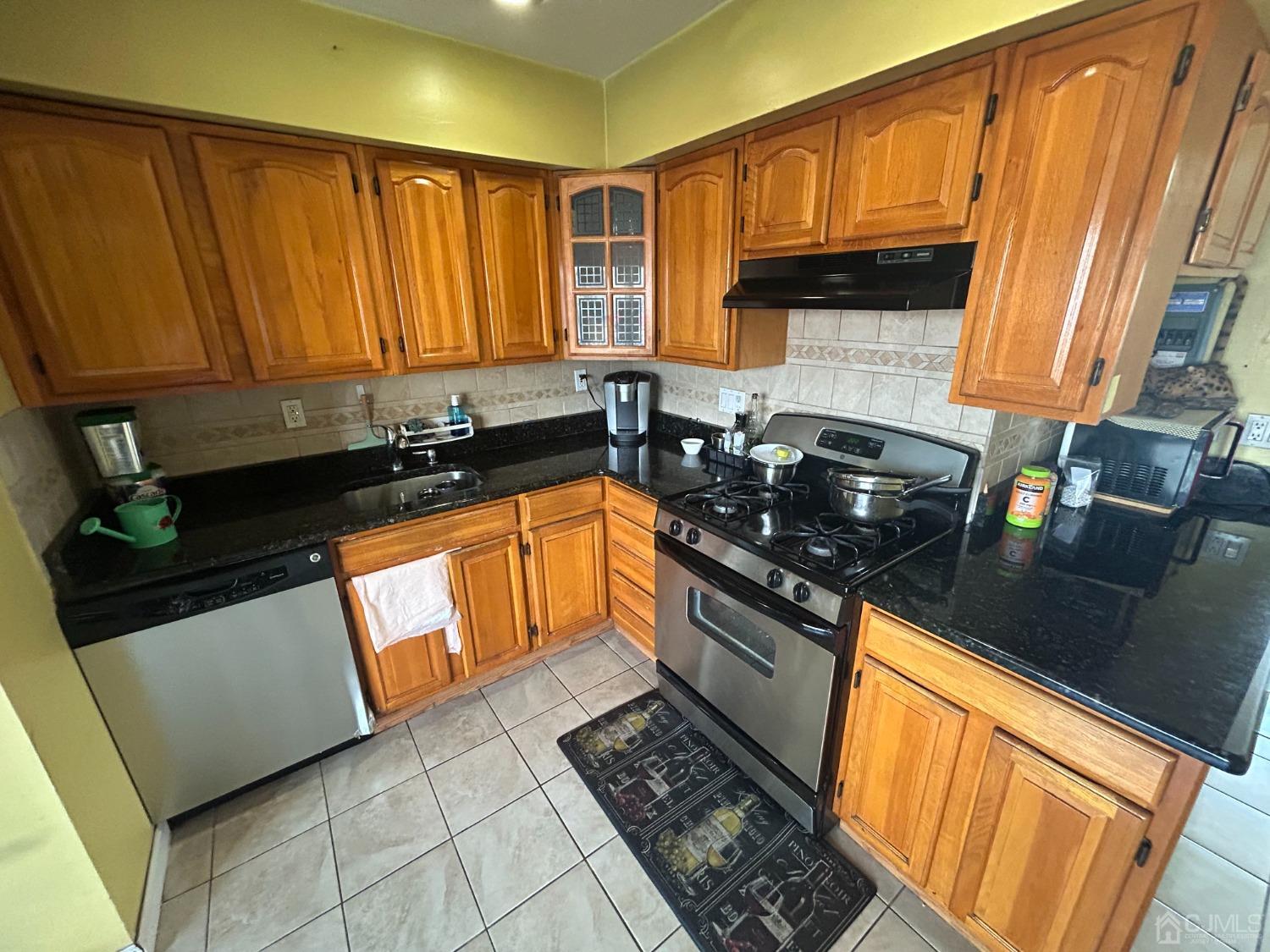 44 Judson Street, Unit 5A Edison, NJ 08837 - Photo 5 of 5 a kitchen with granite countertop a sink stainless steel appliances and cabinets