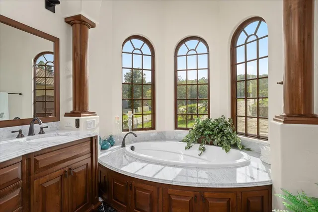 a living room with furniture fireplace and a large window