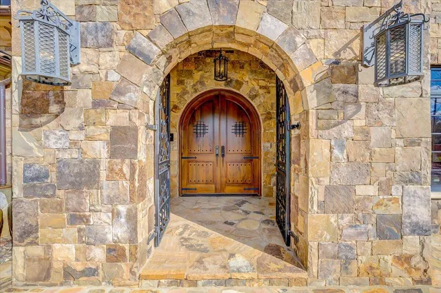 a living room with furniture a fireplace and a floor to ceiling window