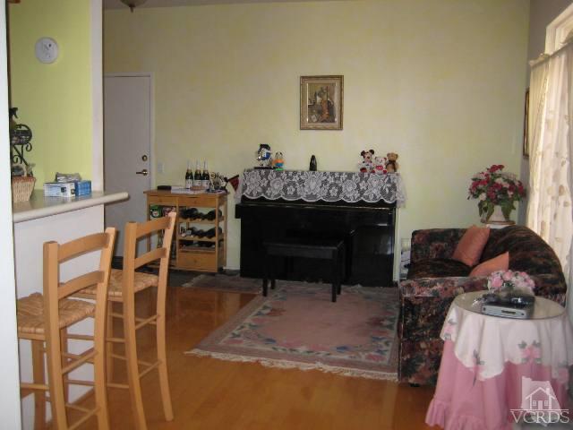 657 Cardinal Ridge Lane Simi Valley, CA 93065 - Photo 5 of 14 a living room with furniture a table and a fireplace