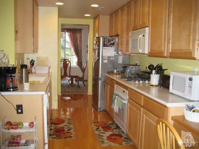 657 Cardinal Ridge Lane Simi Valley, CA 93065 - Photo 6 of 14 a kitchen with stainless steel appliances granite countertop a sink stove and cabinets