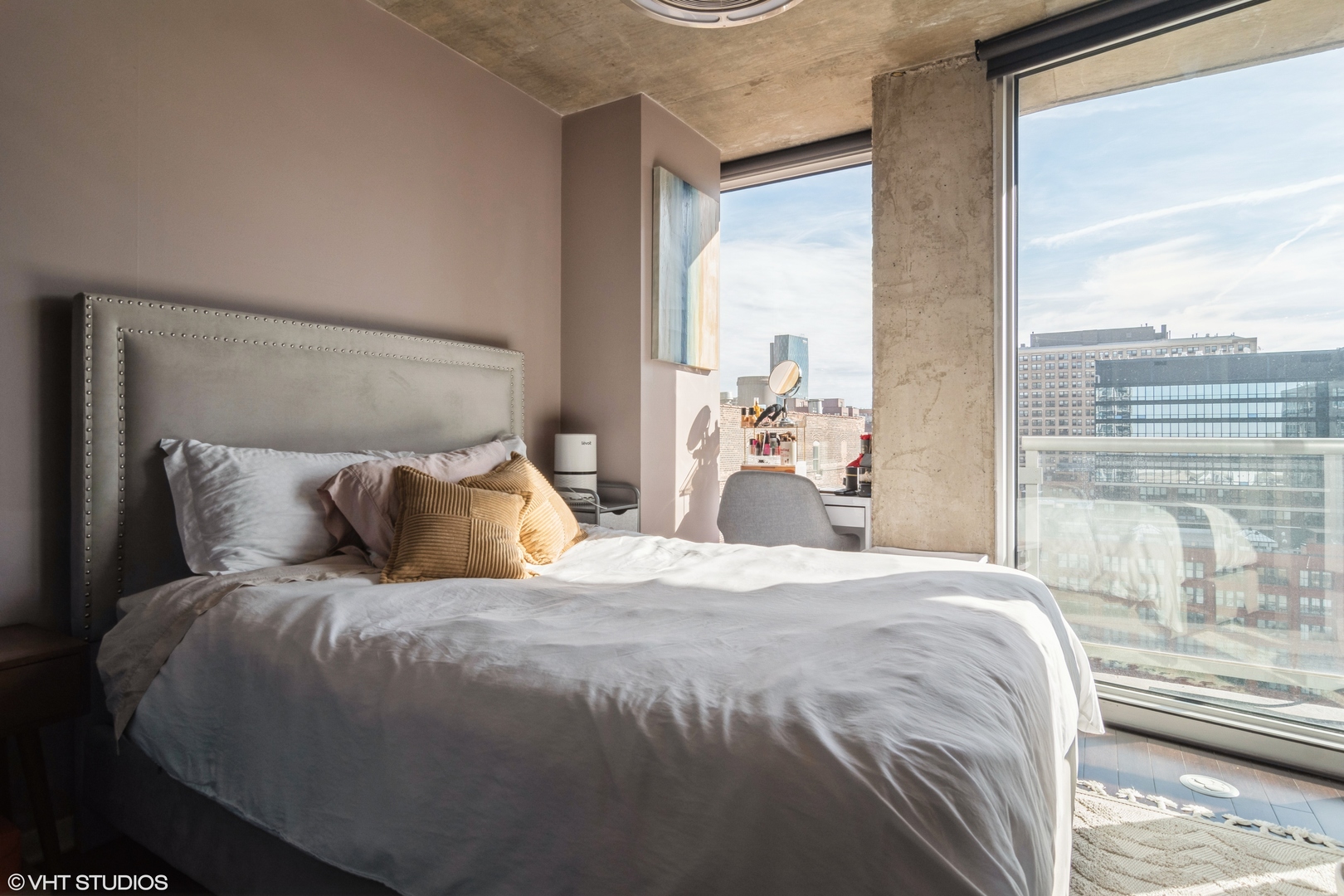 611 South Wells Street, Unit 1608 Chicago, IL 60607 - Photo 11 of 15 a large bed sitting in a bedroom next to a window