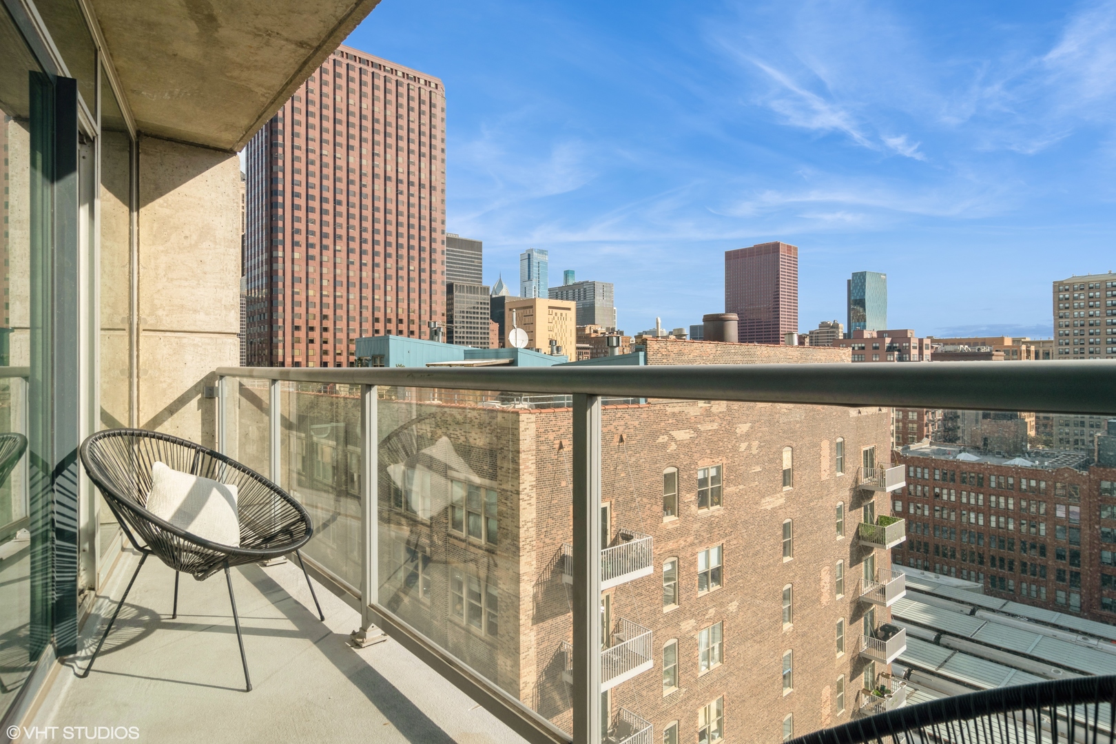 611 South Wells Street, Unit 1608 Chicago, IL 60607 - Photo 14 of 15 a view of a balcony with chairs and iron fence