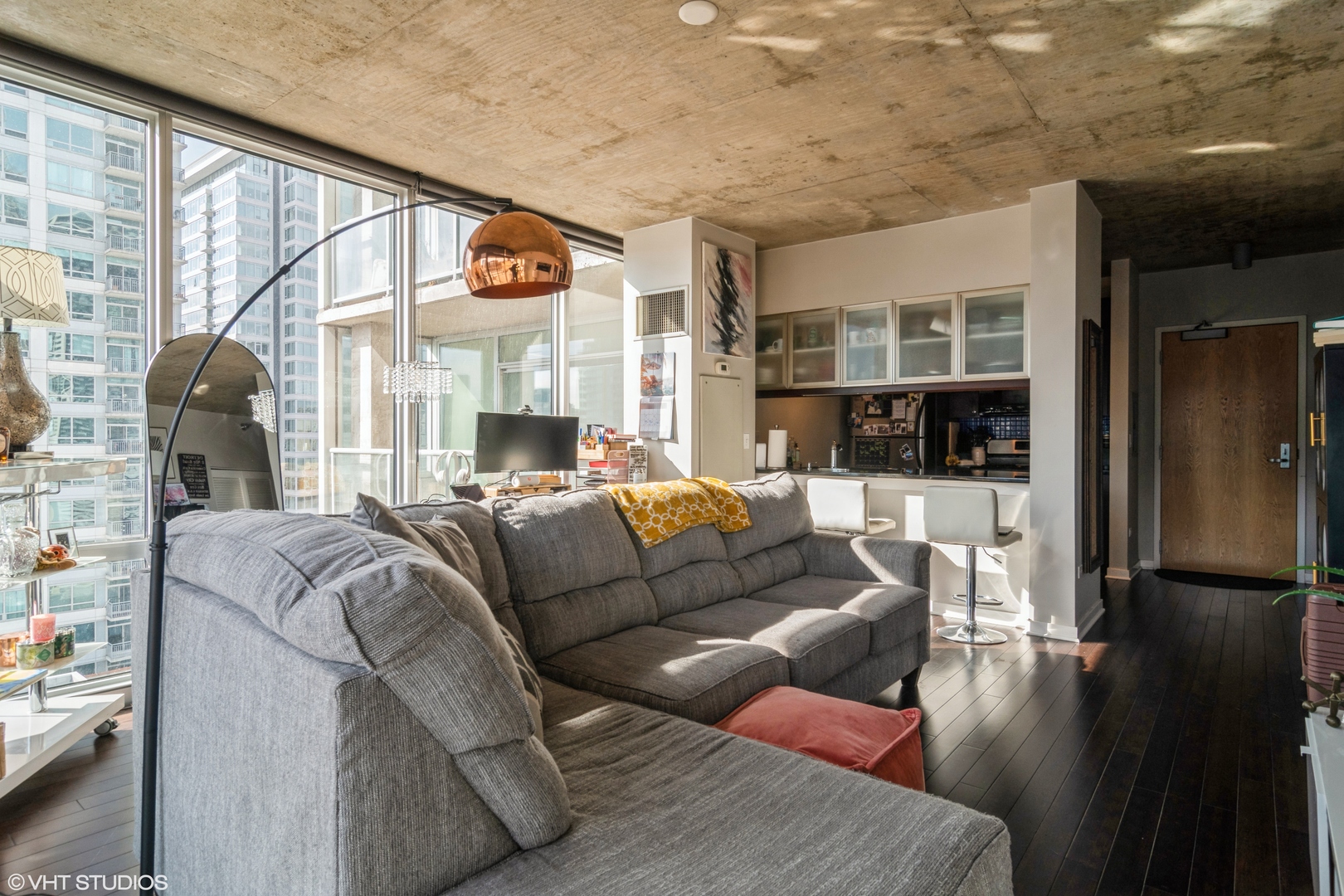 611 South Wells Street, Unit 1608 Chicago, IL 60607 - Photo 7 of 15 a living room with furniture and a floor to ceiling window