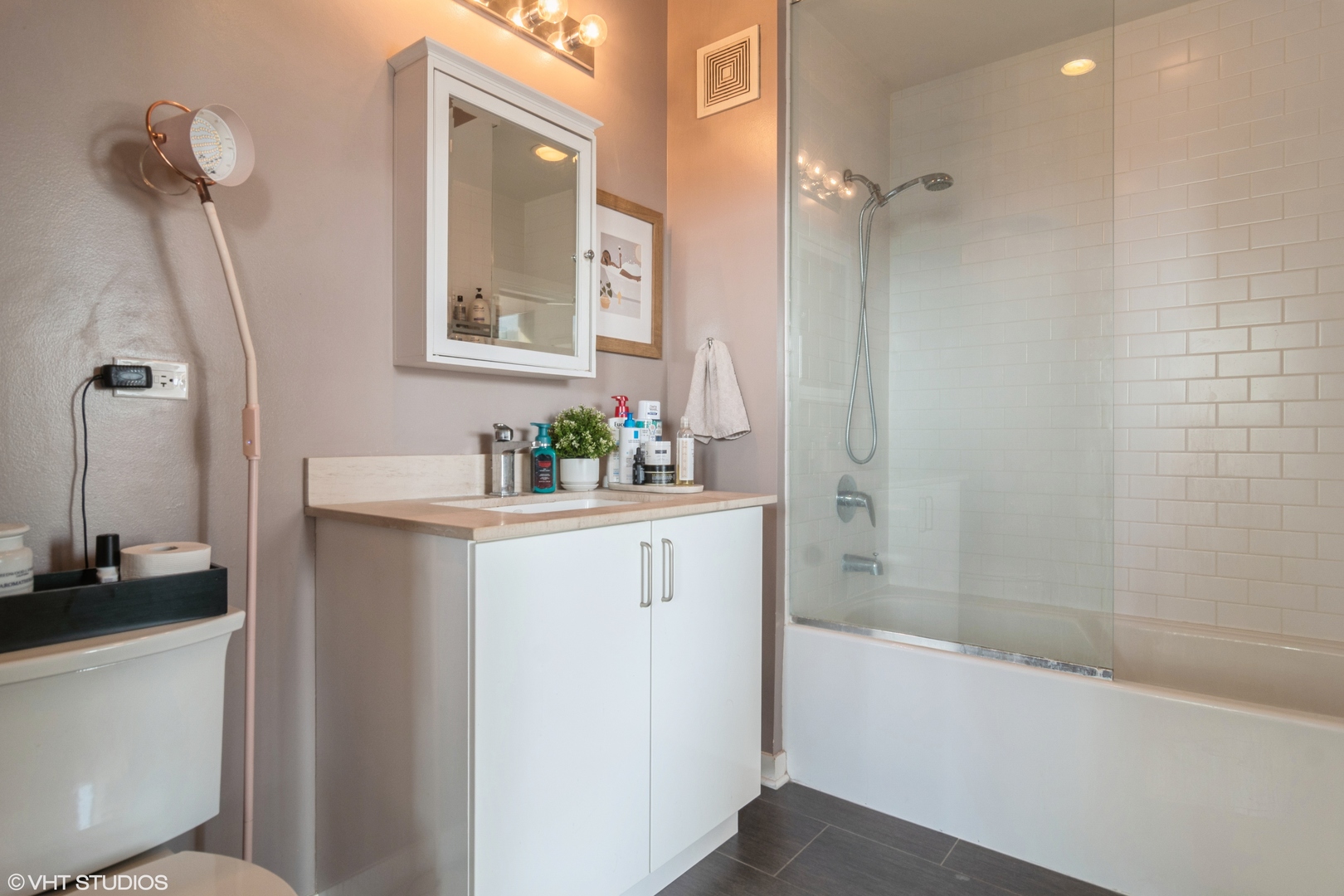 611 South Wells Street, Unit 1608 Chicago, IL 60607 - Photo 9 of 15 a bathroom with a sink a toilet and shower