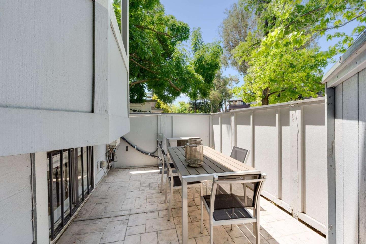 829 Montgomery Street Mountain View, CA 94041 - Photo 27 of 36 a view of a patio with table and chairs with wooden fence and plants