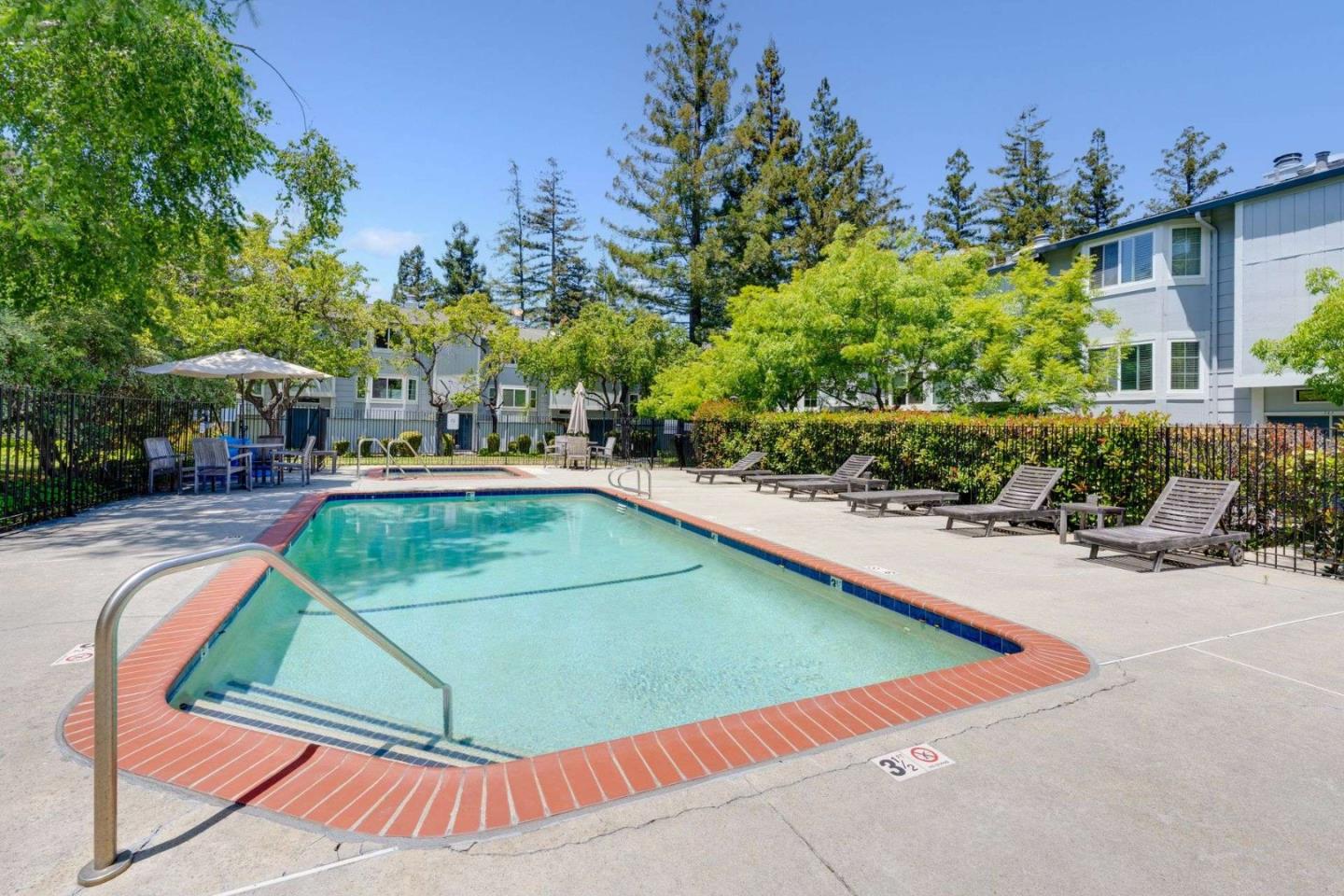 829 Montgomery Street Mountain View, CA 94041 - Photo 32 of 36 a view of a swimming pool with lawn chairs under an umbrella