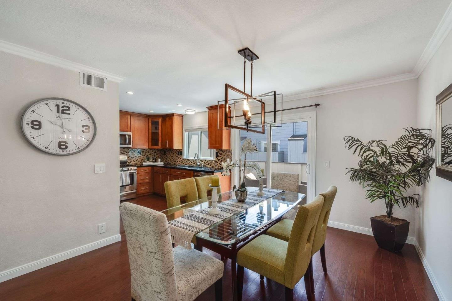 829 Montgomery Street Mountain View, CA 94041 - Photo 8 of 36 a dining room with furniture a potted plant and a ceiling fan