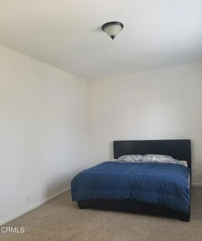 a bedroom with a bed and a night stand