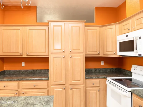a view of a kitchen with a sink and a refrigerator