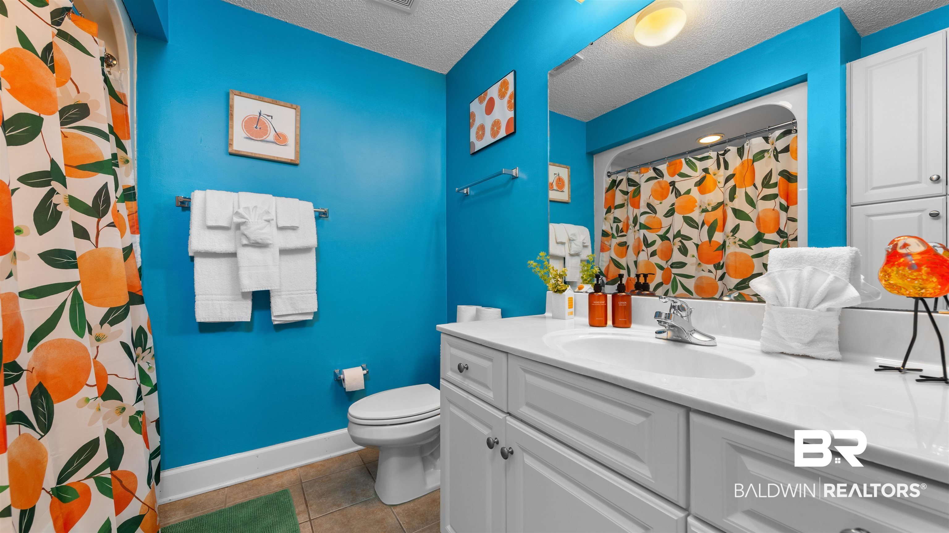 27582 Canal Road, Unit 2207 Orange Beach, AL 36561 - Photo 11 of 25 Bathroom with curtained shower, vanity, dark tile patterned flooring, and a textured ceiling