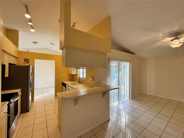 a kitchen with stainless steel appliances a sink stove and refrigerator