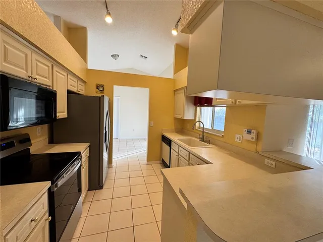 a living room with hard wood floors and a ceiling fan