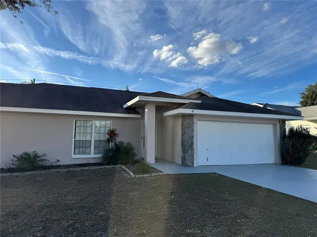 a view of a house with a yard and garage