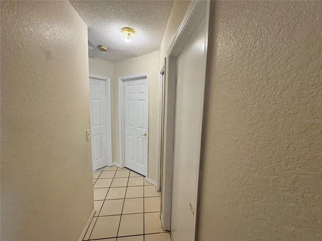 a view of wooden floor and a chandelier fan in a room