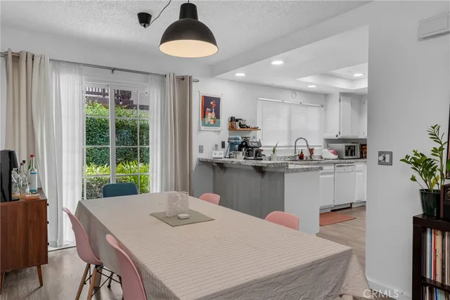 a kitchen with kitchen island a stove a table and chairs in it