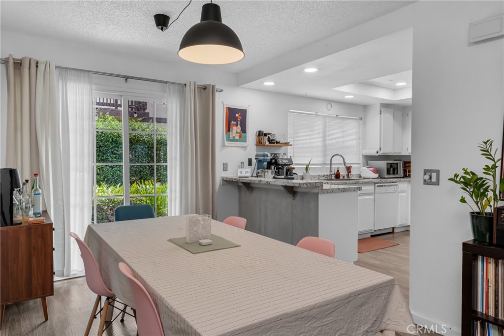 4424 San Jose Street, Unit 3 Montclair, CA 91763 - Photo 12 of 33 a kitchen with kitchen island a stove a table and chairs in it