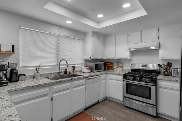 a stove top oven sitting inside of a kitchen