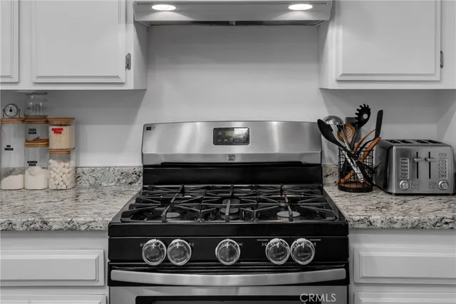 a kitchen with a sink and wooden floor