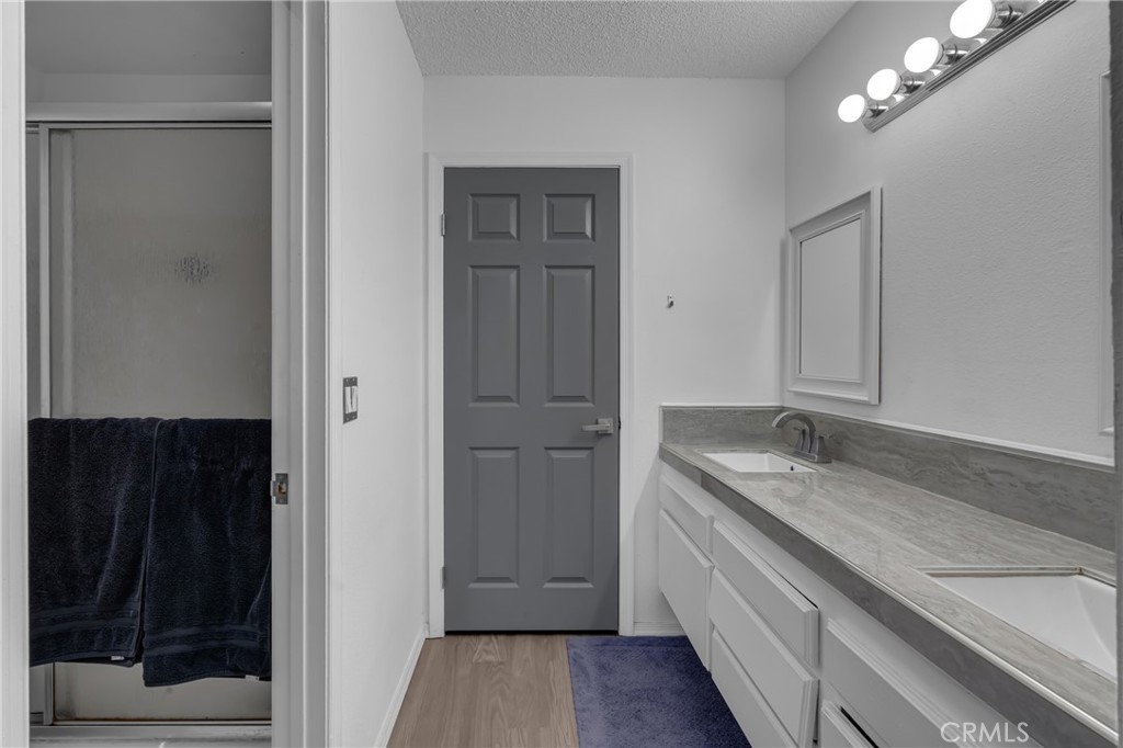 4424 San Jose Street, Unit 3 Montclair, CA 91763 - Photo 23 of 33 a bathroom with a granite countertop sink a toilet and shower
