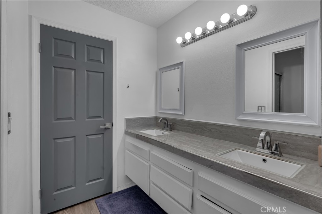 4424 San Jose Street, Unit 3 Montclair, CA 91763 - Photo 24 of 33 a bathroom with double sink and a mirror