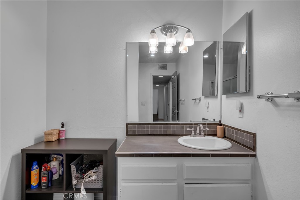 4424 San Jose Street, Unit 3 Montclair, CA 91763 - Photo 30 of 33 a bathroom with a sink and a mirror