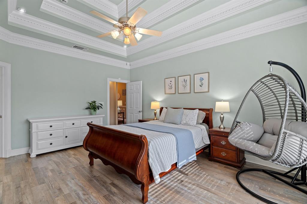 112 Waterfall Court Azle, TX 76020 - Photo 18 of 40 a spacious bedroom with a bed a couch and dresser