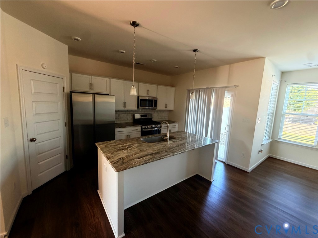 12737 Deep Wl Road Midlothian, VA 23112 - Photo 6 of 17 a kitchen with kitchen island white cabinets and stainless steel appliances