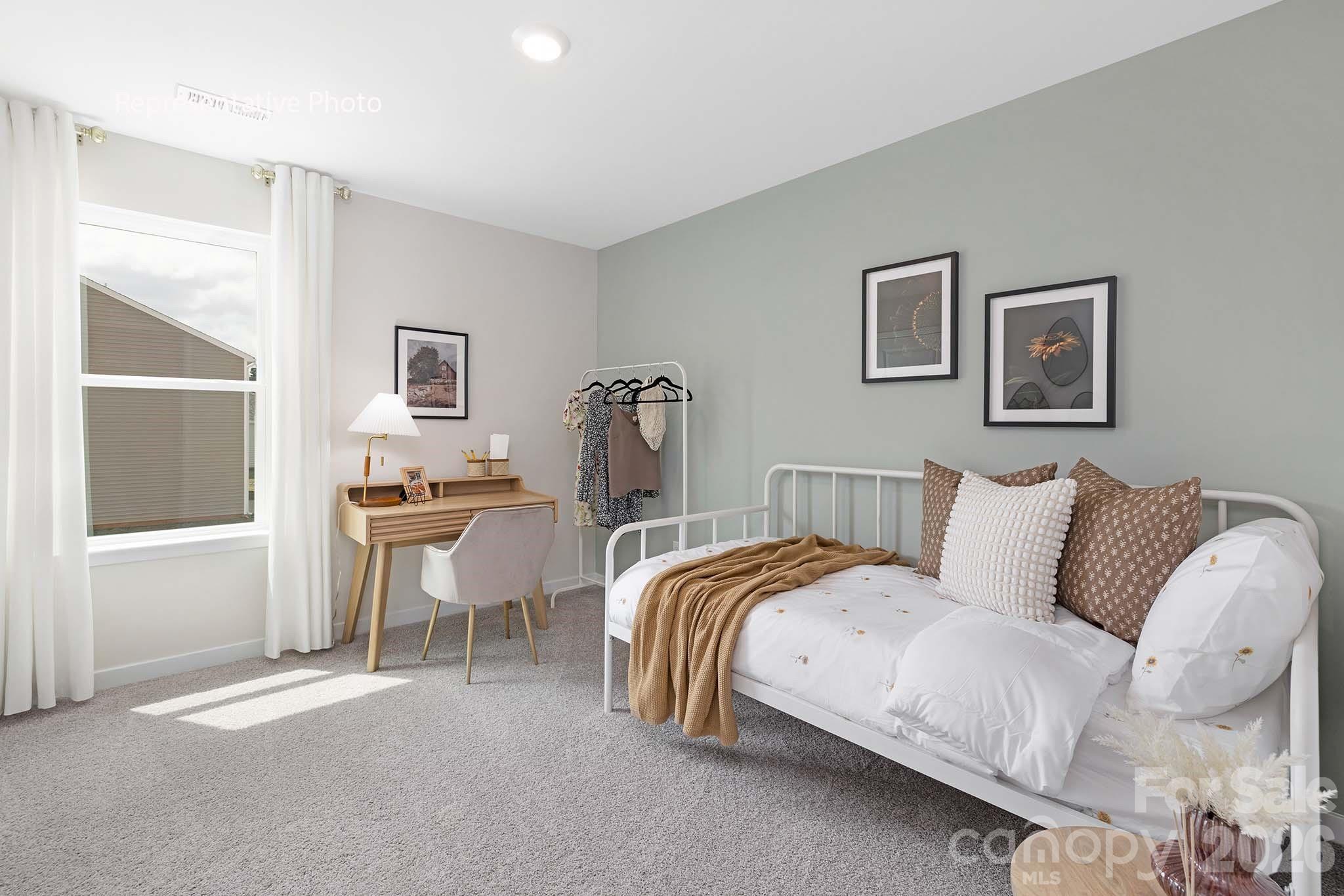 3036 Arundel Court Maiden, NC 28650 - Photo 16 of 22 a spacious bedroom with a bed and a table