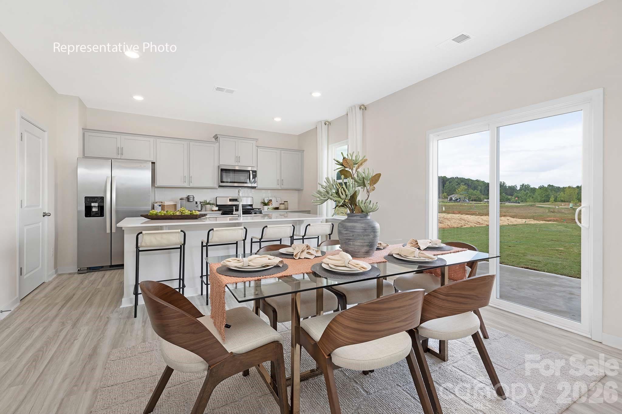 3036 Arundel Court Maiden, NC 28650 - Photo 10 of 22 a dining room with furniture and a floor to ceiling window