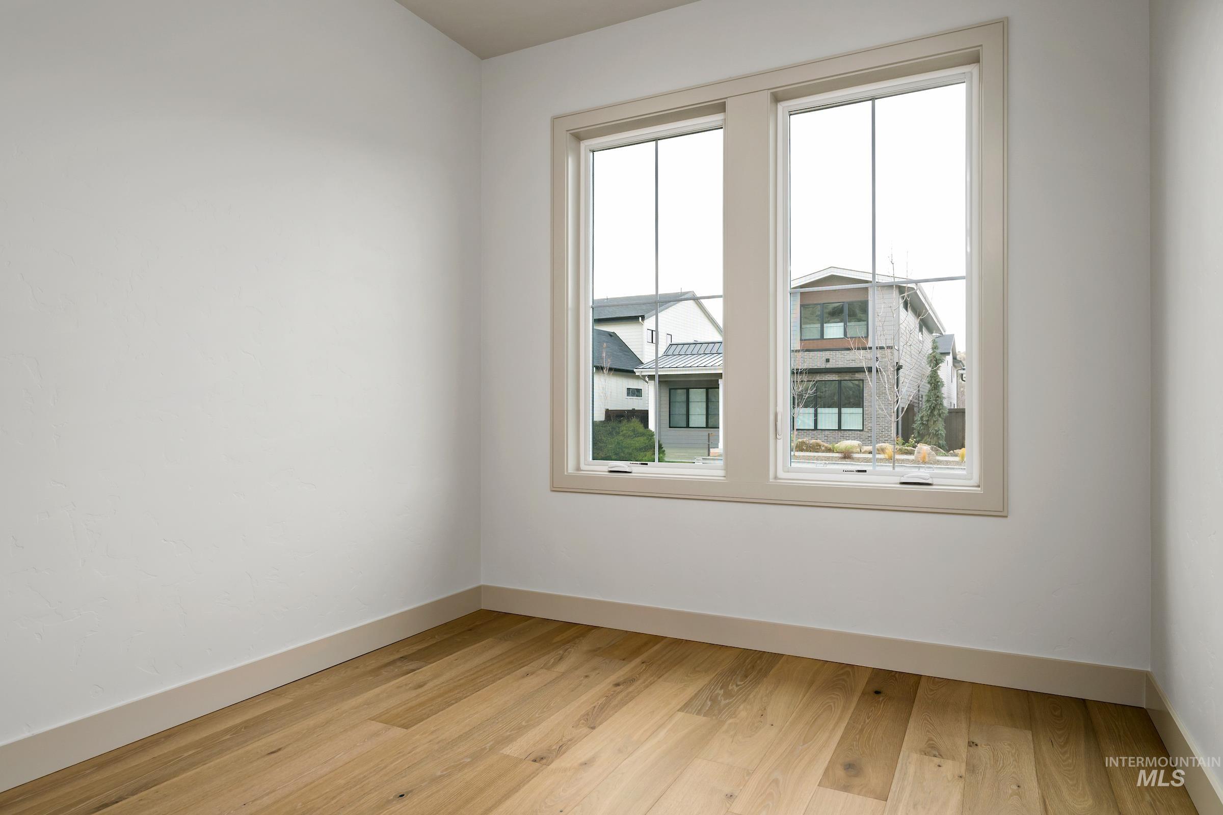 11696 North Rabbitbrush Way Boise, ID 83714 - Photo 10 of 32 Spare room with light wood-style flooring and baseboards
