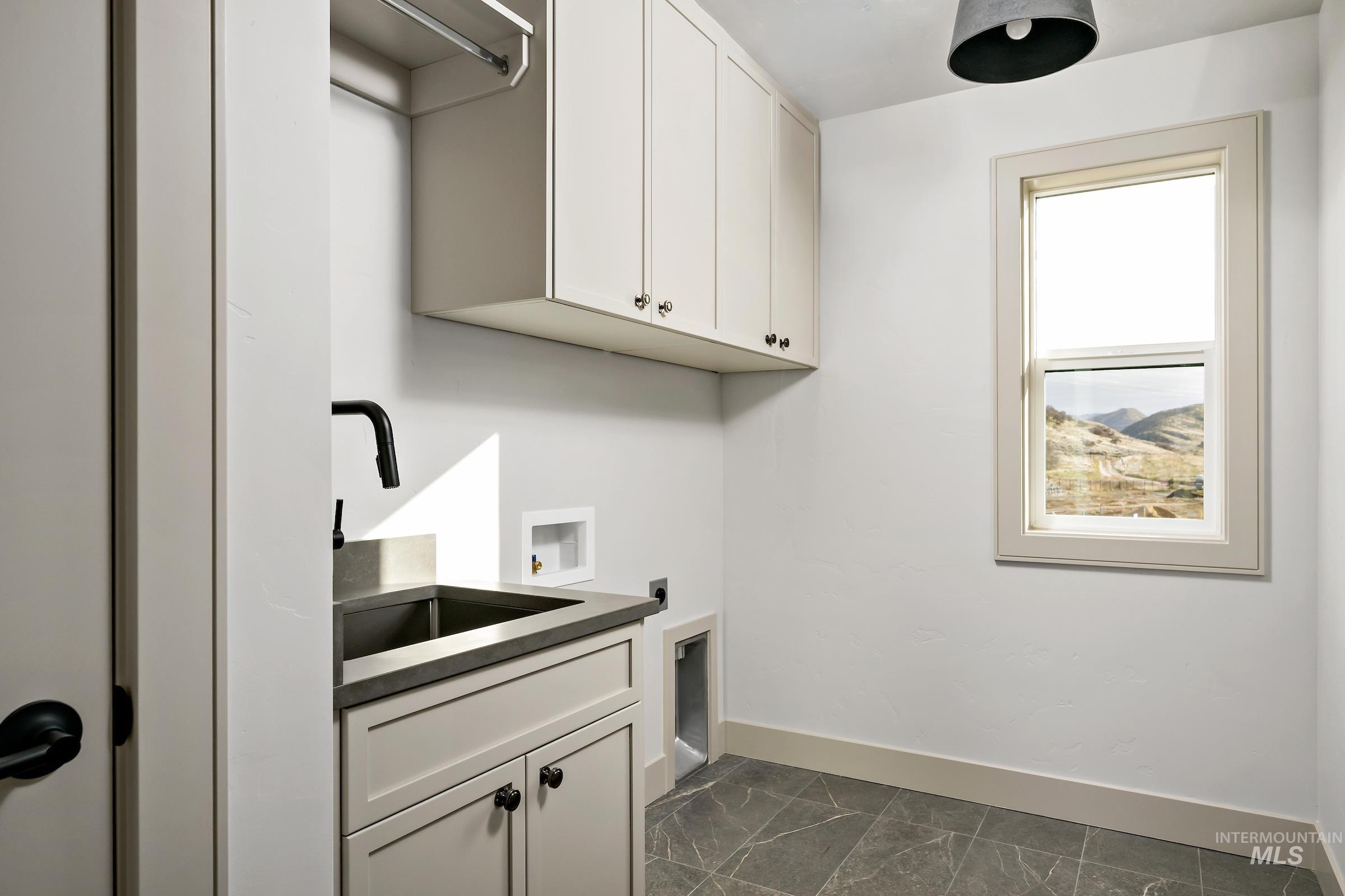 11696 North Rabbitbrush Way Boise, ID 83714 - Photo 21 of 32 Laundry area with cabinet space, hookup for a washing machine, dark marble finish flooring, and hookup for an electric dryer