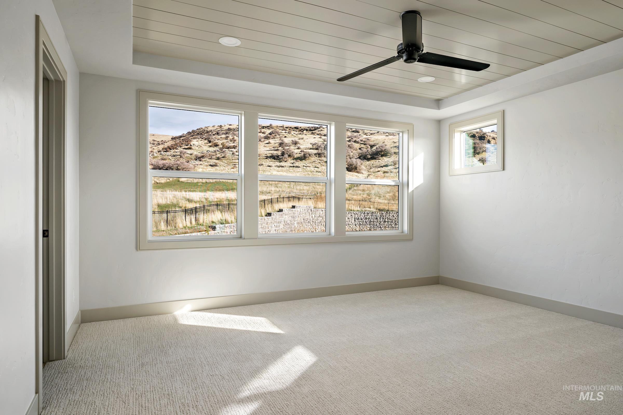 11696 North Rabbitbrush Way Boise, ID 83714 - Photo 22 of 32 Spare room with light colored carpet, ceiling fan, and wooden ceiling