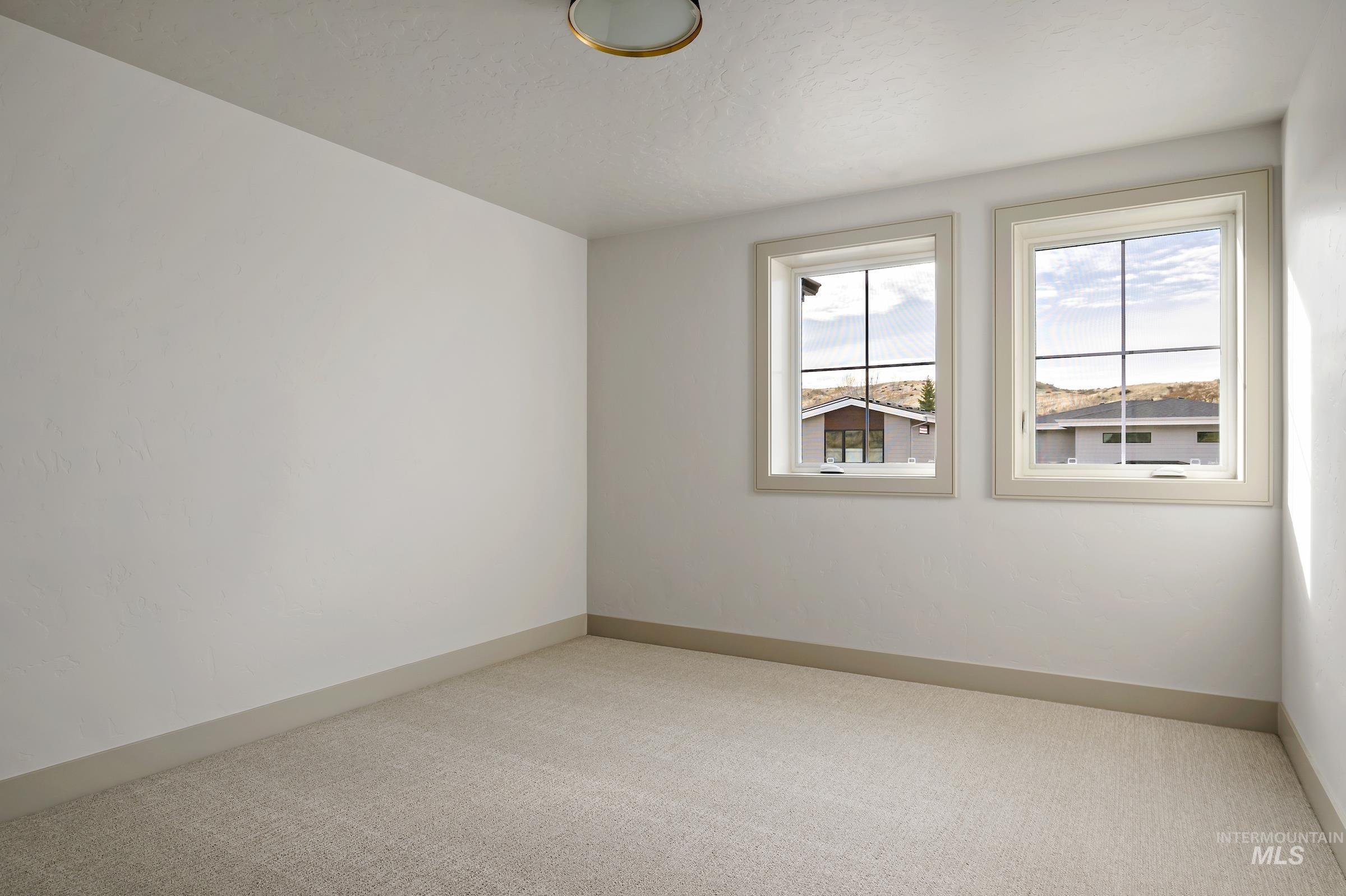 11696 North Rabbitbrush Way Boise, ID 83714 - Photo 30 of 32 Empty room featuring carpet floors and baseboards