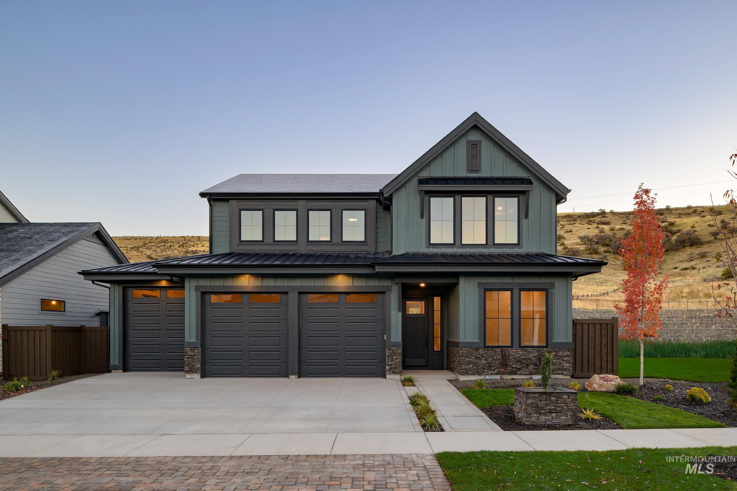 11696 North Rabbitbrush Way Boise, ID 83714 - Photo 31 of 32 View of front of home with concrete driveway, board and batten siding, stone siding, and a metal roof