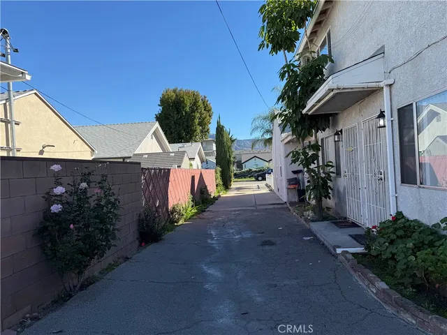 a front view of a house with plants