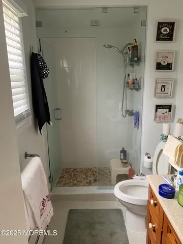 a bathroom with a toilet and a shower