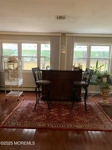 a living room filled with furniture hardwood floor and a table
