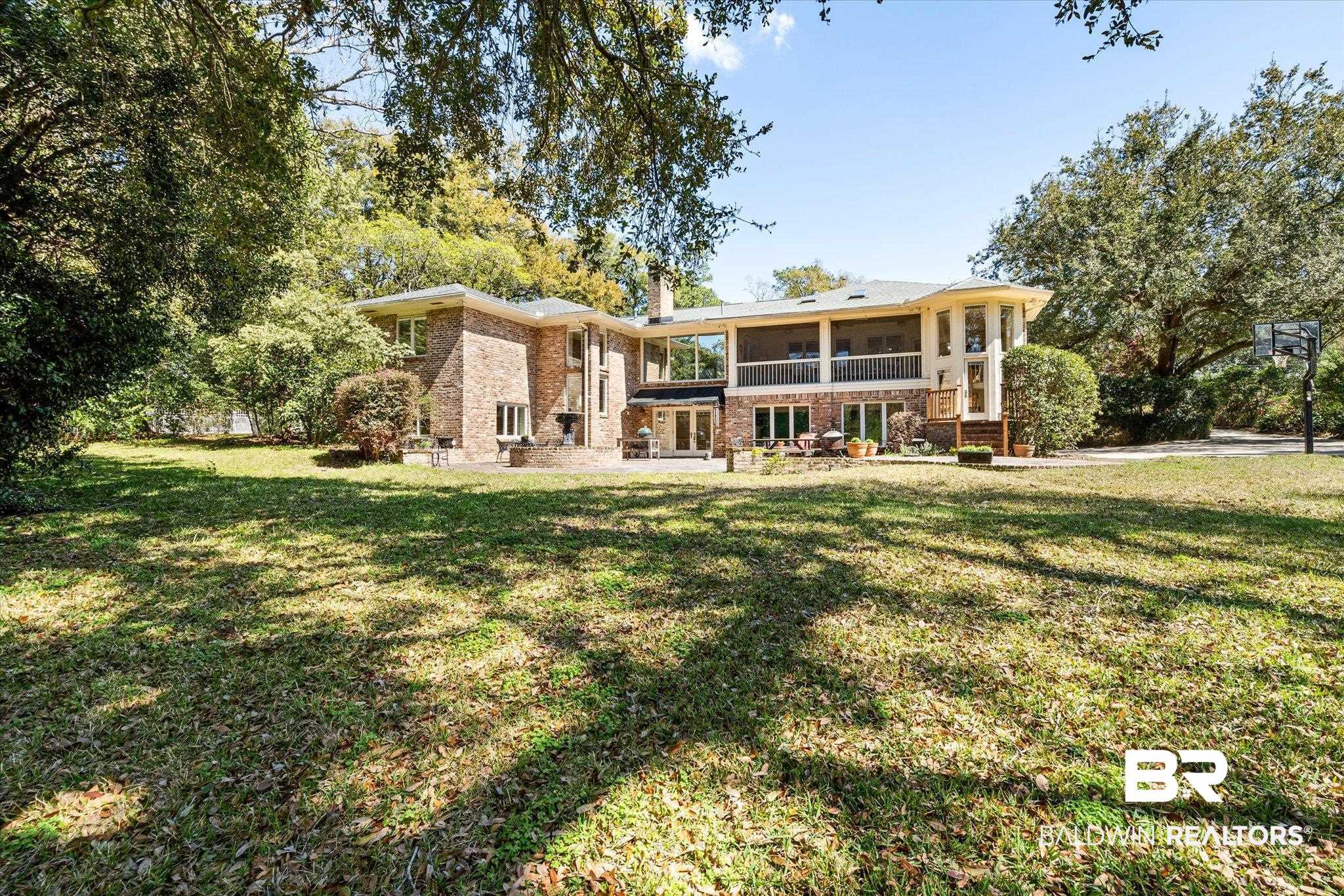 4 Kingsway Mobile, AL 36608 - Photo 36 of 44 Back of house with a lawn, brick siding, a sunroom, and a chimney