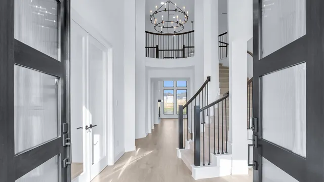 a view of a hallway with wooden floor and entryway