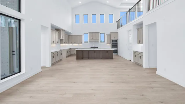 a large white kitchen with cabinets and stainless steel appliances