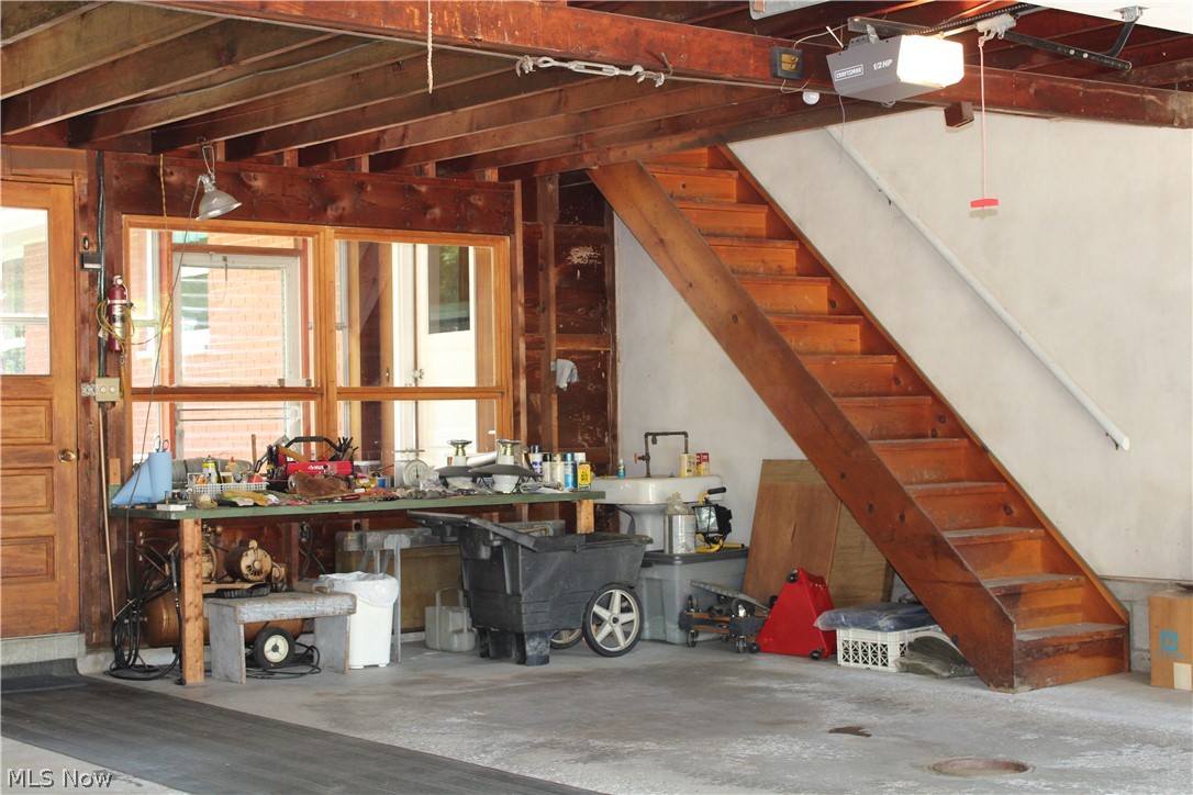8818 Carnes Road Chagrin Falls, OH 44023 - Photo 22 of 30 Extra large two car garage with drain, water, stairs to attic and electric openers.