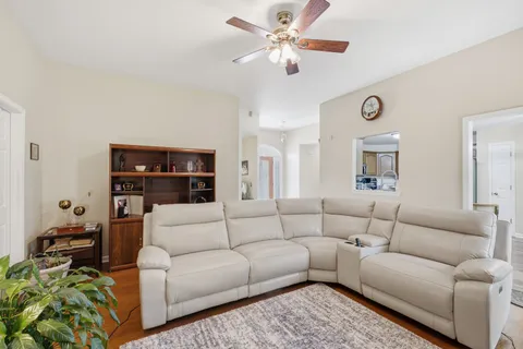 a living room with furniture and a chandelier