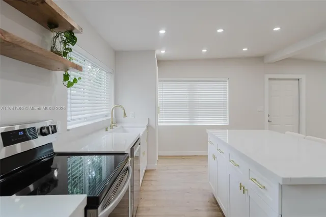 a kitchen with a sink appliances and cabinets