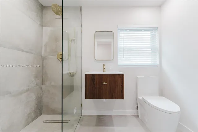 a bathroom with a toilet a sink and shower