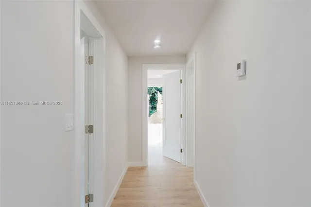 a view of a hallway with wooden floor