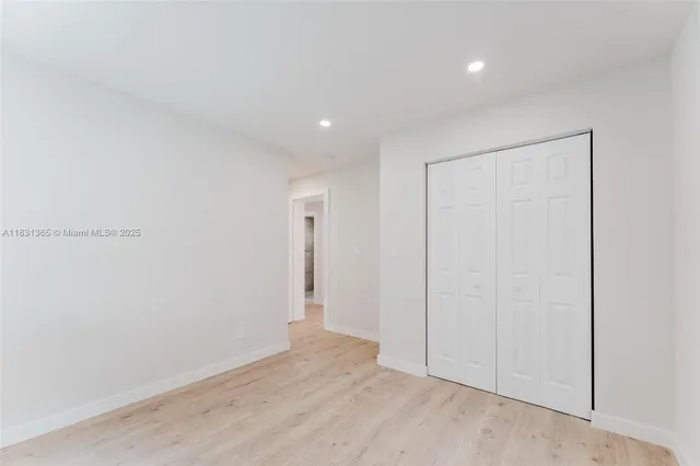 a view of kitchen with refrigerator and window