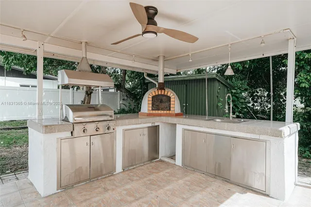 a kitchen with stainless steel appliances granite countertop a sink and a stove