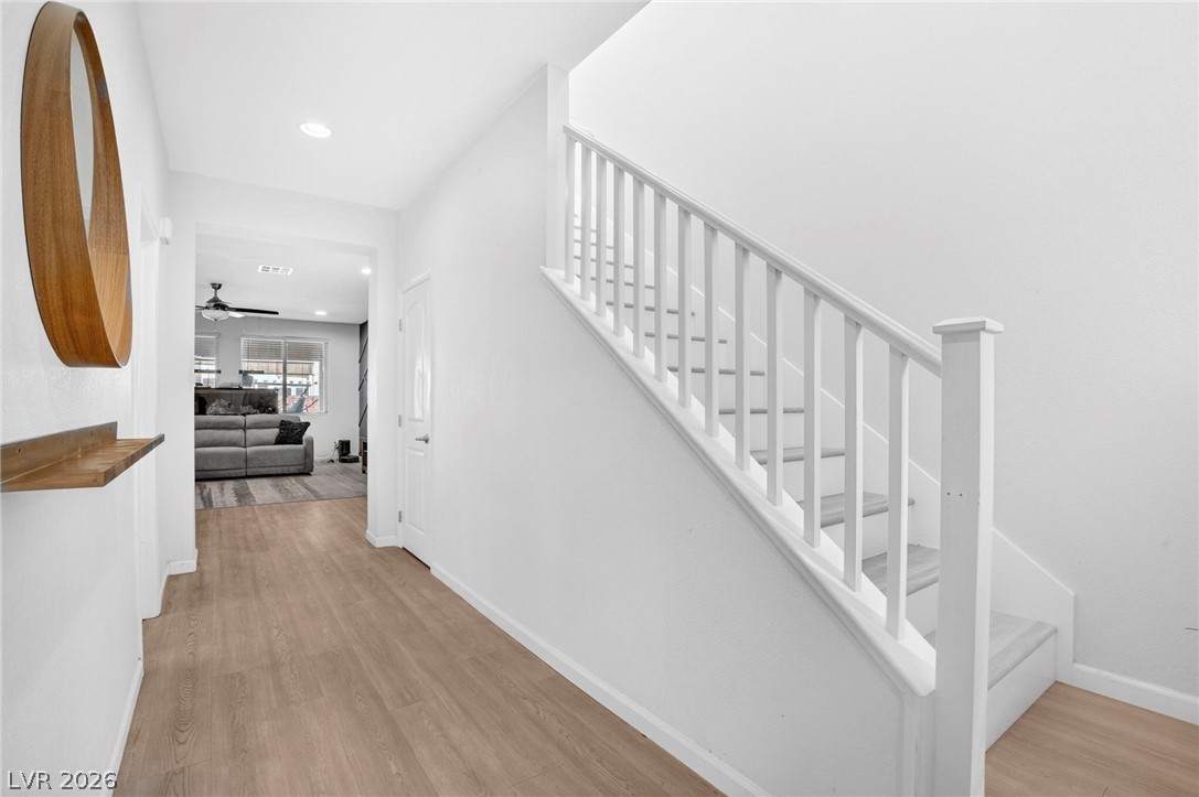 6281 Angora Peak Lane Las Vegas, NV 89115 - Photo 7 of 34 A graceful staircase ascends from a well-lit foyer with light-toned flooring.