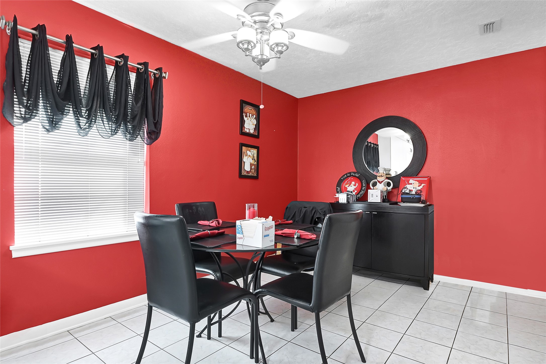 4831 Knickerbocker Street Houston, TX 77035 - Photo 28 of 50 Dining nook with red accent wall, contemporary lighting, and large window.